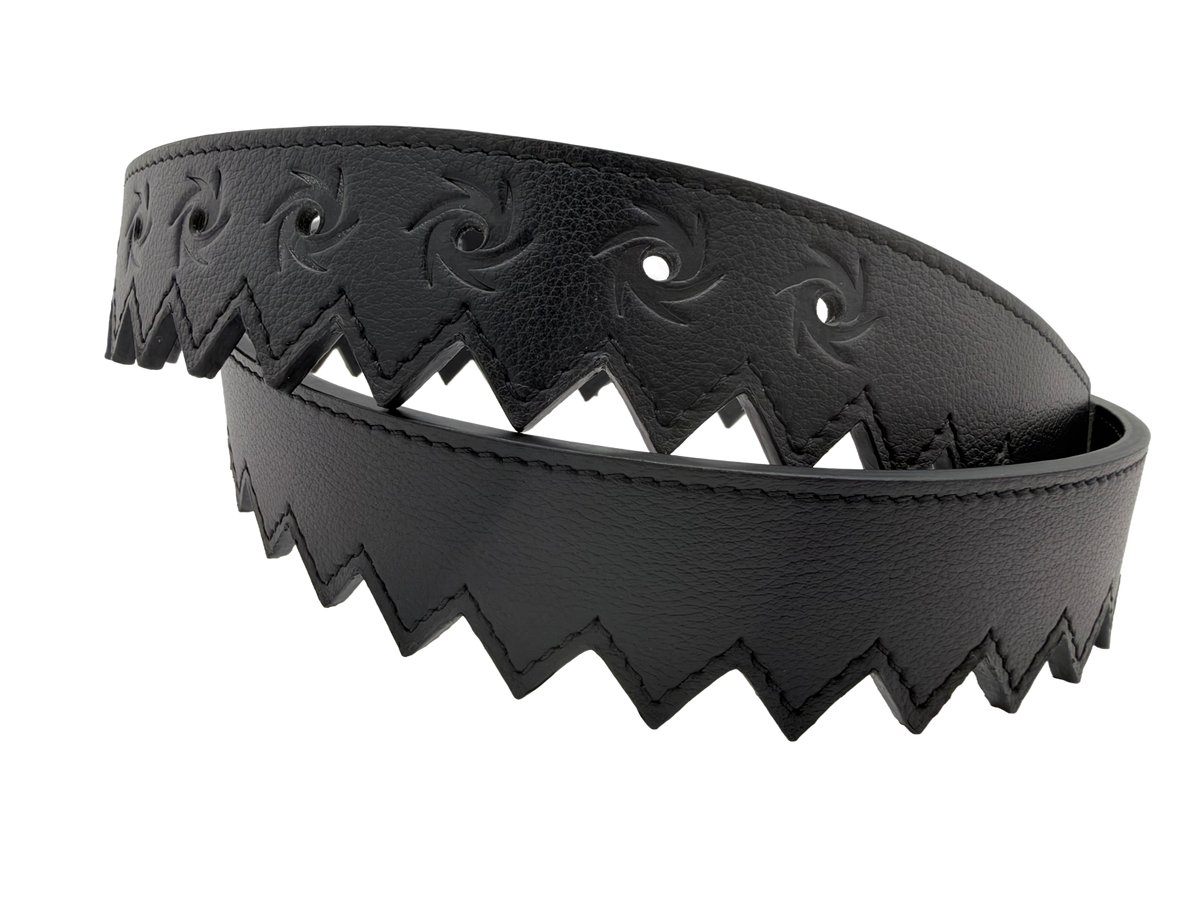 Coiled black leather Ripcord Belt showing the serrated zigzag edge and embossed swirl pattern